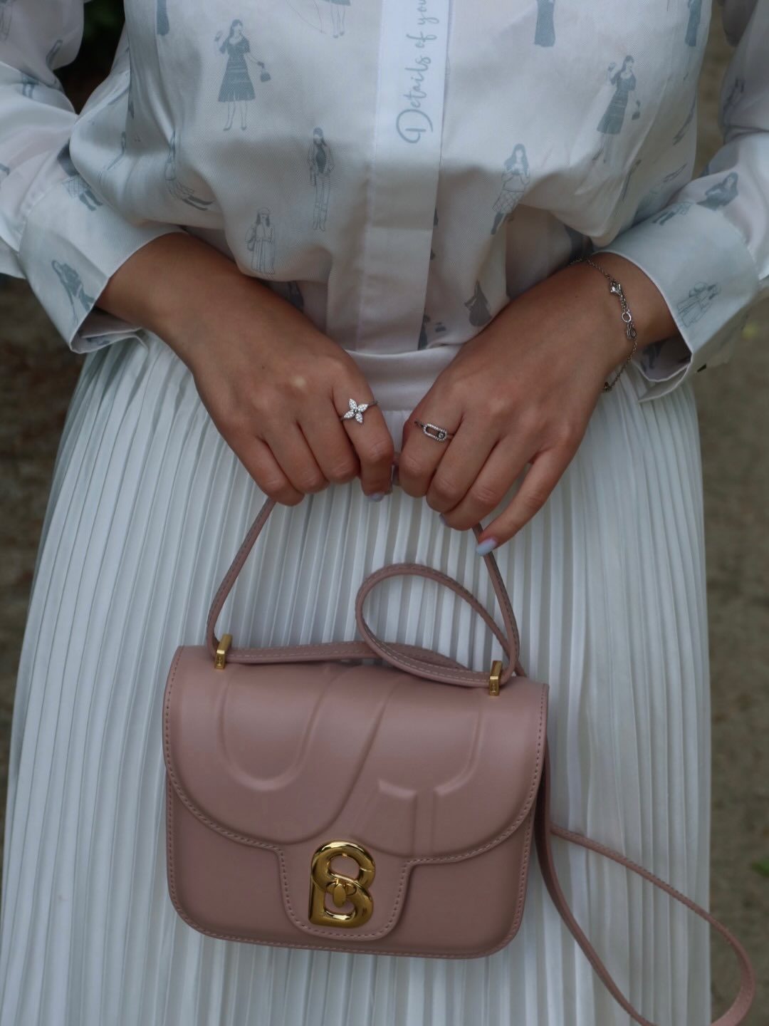 Buttonscarves — printed silk shirt, white pleated skirt and blush shoulder bag, frame 5