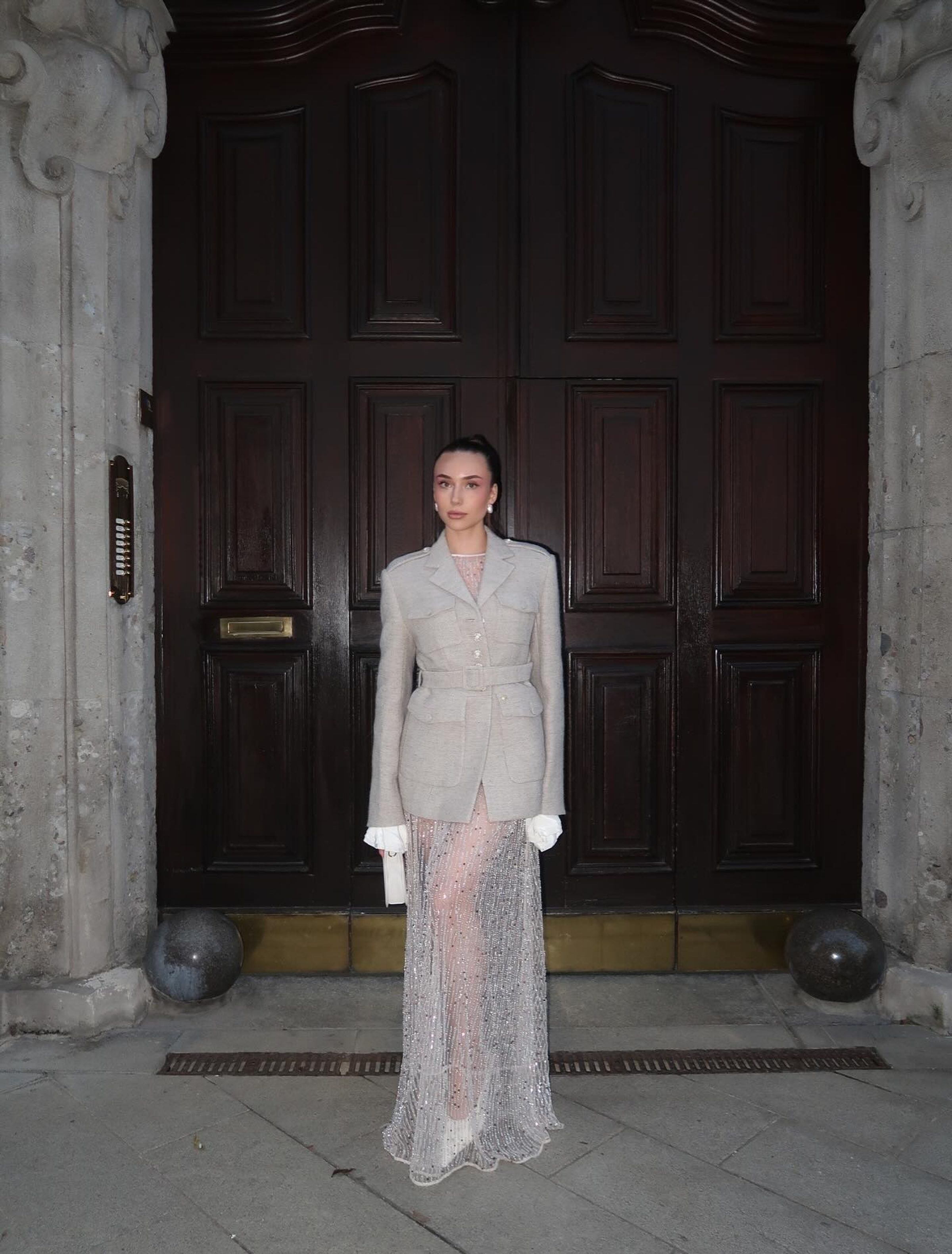 Full-length editorial outside a vintage doorway, evening look